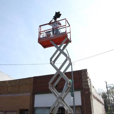 Cinematographer Devon Leesley operating a movie camera on a high-elevation lift for a crane shot on the set of Apparition