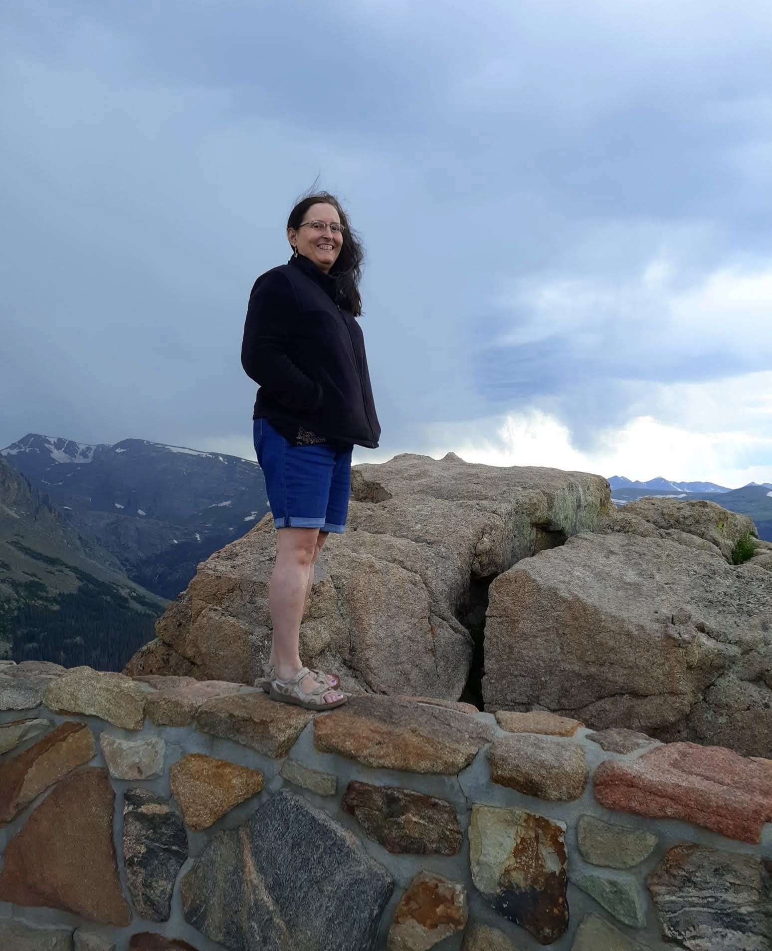 Musician Tammy Burke posing in the scenic Rocky Mountains for her official Apparition film profile.